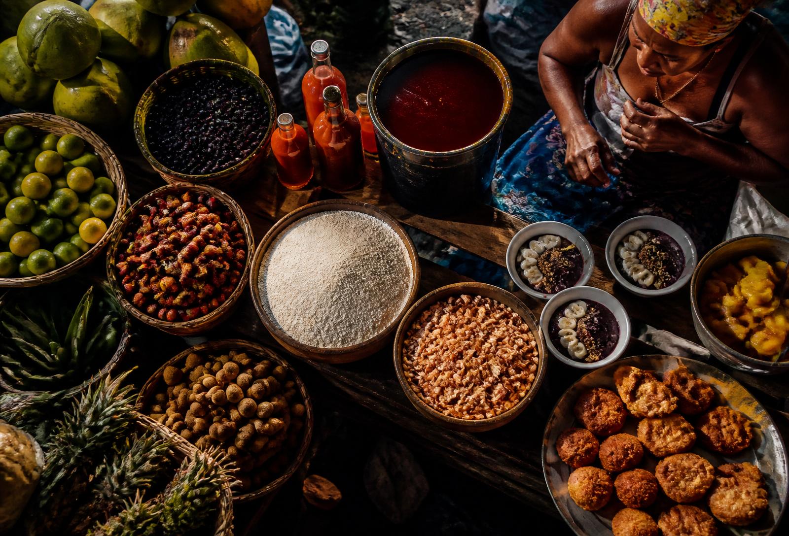 A Brazilian market stall filled with tropical fruit, flours and regional ingredients
