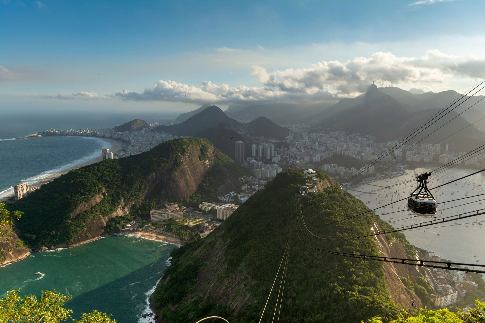 Cable car crossing above Guanabara Bay towards Sugarloaf Mountain